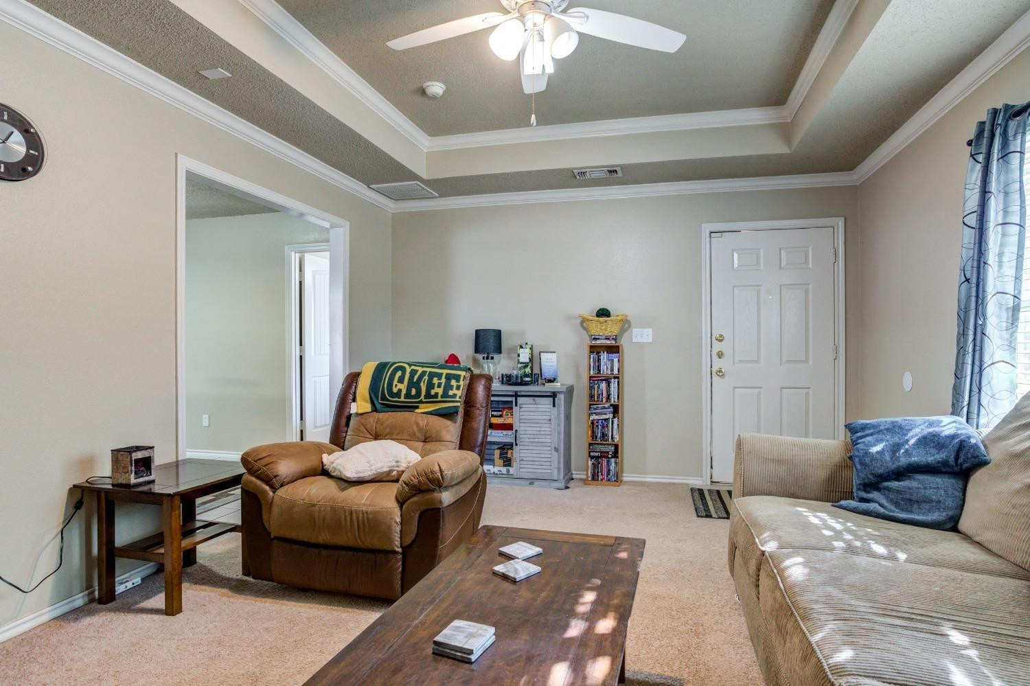 3114 109th Street Lubbock, TX 79423 - Photo 7 of 43 a bedroom with furniture and a chandelier