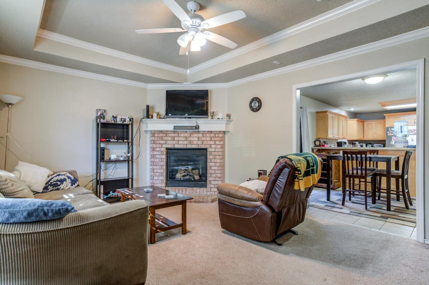 3114 109th Street Lubbock, TX 79423 - Photo 8 of 43 a living room with furniture and a fireplace