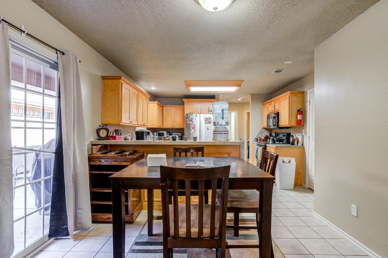 3114 109th Street Lubbock, TX 79423 - Photo 10 of 43 a view of a dining room with furniture and window