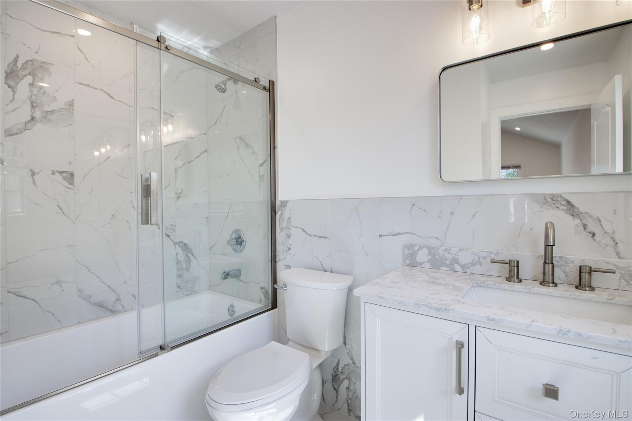 46 Linwood Road North Port Washington, NY 11050 - Photo 16 of 19 a bathroom with a sink a toilet and shower