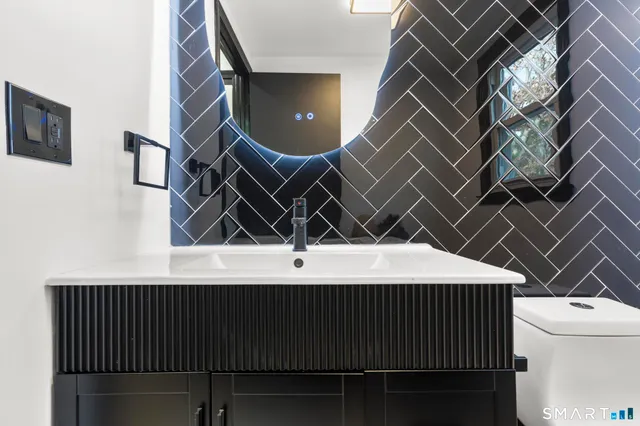 a white toilet sitting next to a bathroom sink