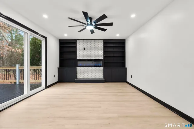 a view of a livingroom with a ceiling fan and window