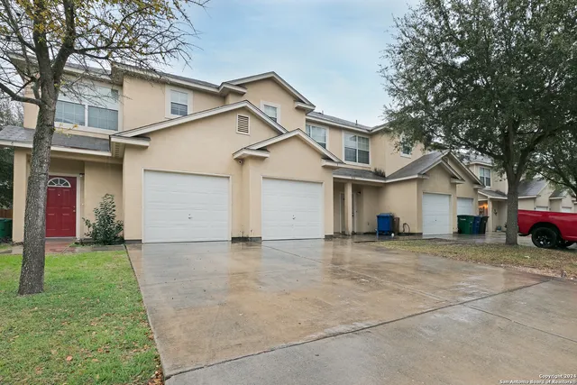a view of a house with a yard and garage