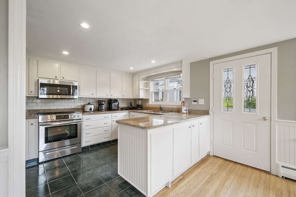 6 Treat Road Marblehead, MA 01945 - Photo 12 of 22 a kitchen with stainless steel appliances granite countertop a stove a sink and a refrigerator