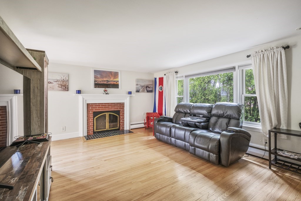 6 Treat Road Marblehead, MA 01945 - Photo 4 of 22 a living room with furniture a large window and a fireplace