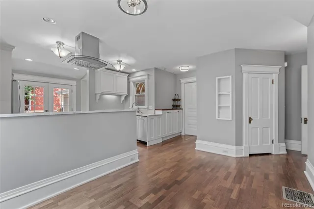 a view of a kitchen with furniture and wooden floor
