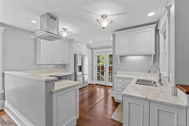 a kitchen with a stove a refrigerator and a sink
