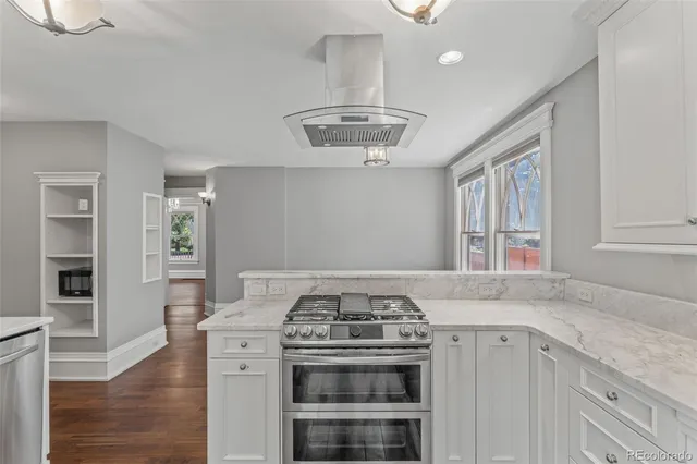 a kitchen with granite countertop a stove and a sink