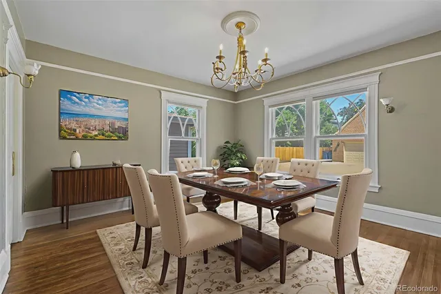 a view of a dining room with furniture a chandelier and wooden floor