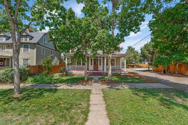 a front view of a house with a yard and shrubs