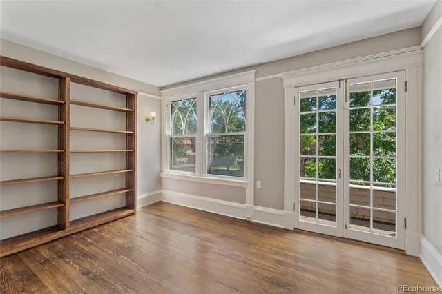 a view of wooden floor and windows in a room