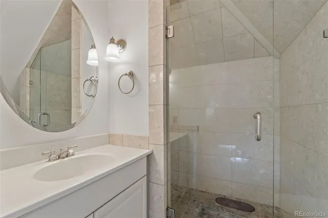 a bathroom with a mirror sink and vanity