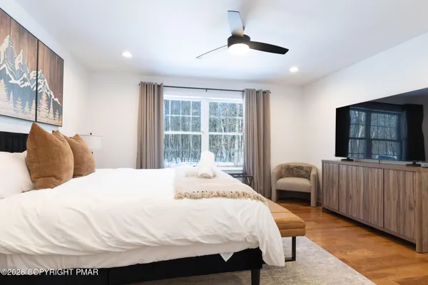 a bedroom with a bed and a large window