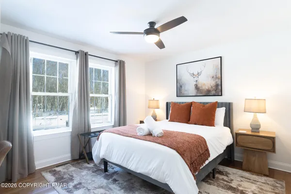 a bedroom with a large bed and a window