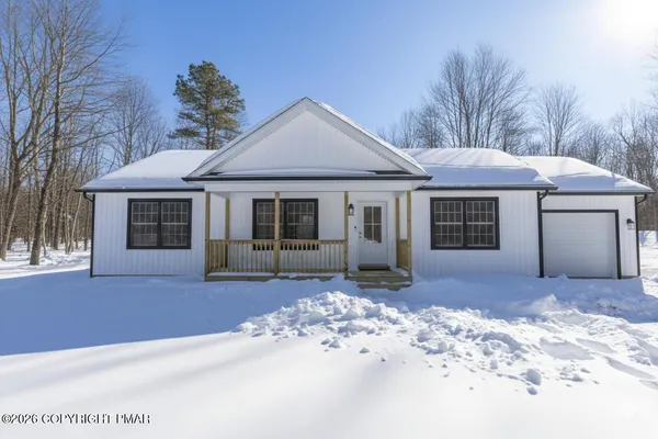 a front view of a house with a garden and yard