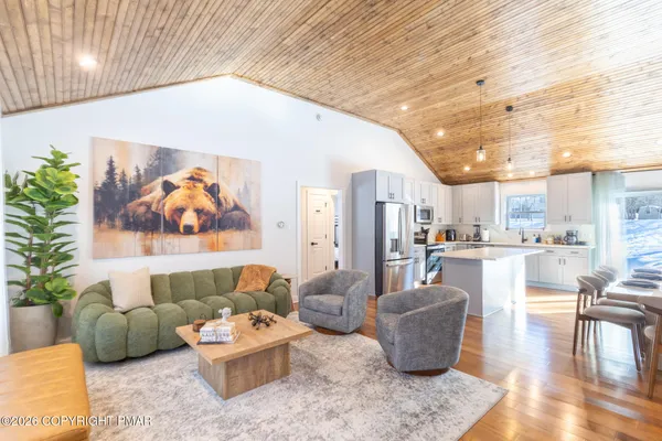 a living room with furniture and kitchen view