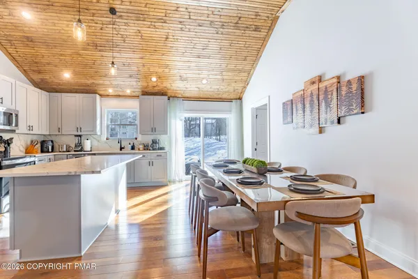 a kitchen with a table and chairs in it