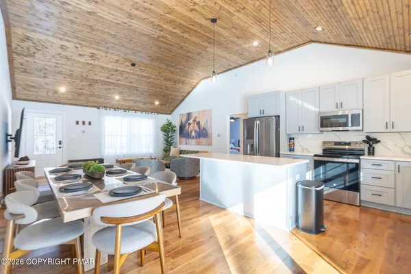 a kitchen with stainless steel appliances kitchen island granite countertop a sink and cabinets