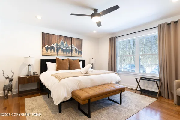 a bedroom with a bed and a large window