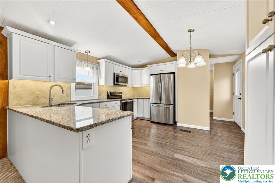 12 Revolutionary Road Mount Bethel, PA 18343 - Photo 9 of 53 a kitchen with stainless steel appliances granite countertop a sink refrigerator and cabinets
