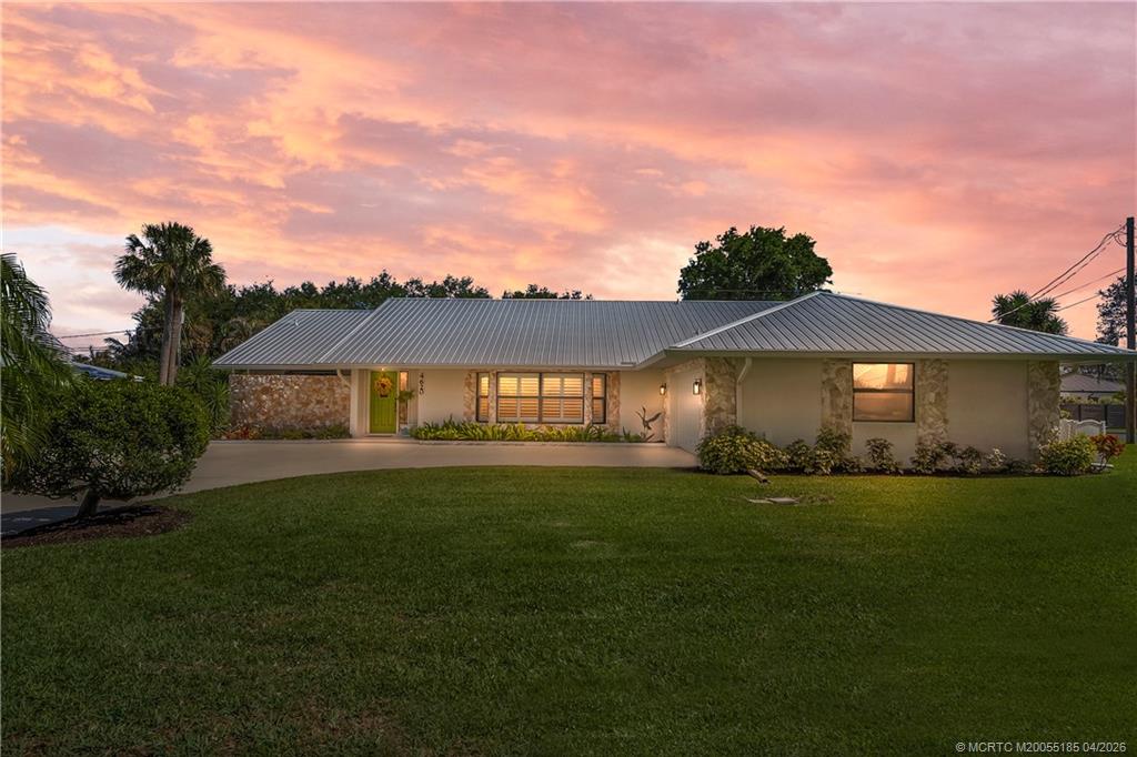 4620 Southeast Quail Trail Stuart, FL 34997 - Photo 1 of 71 a front view of a house with a yard