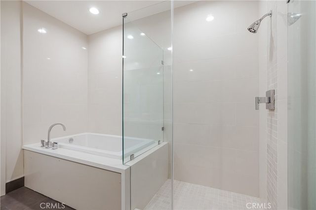 a bathroom with a bathtub and a shower