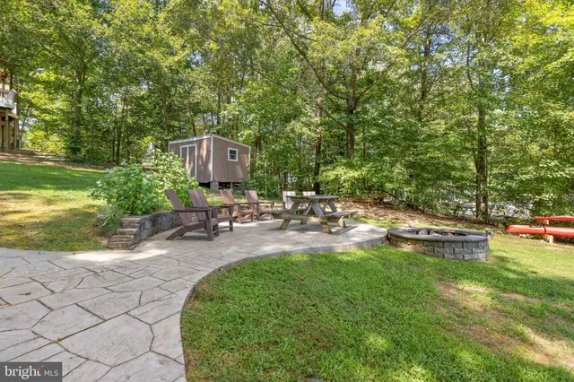 a view of a swimming pool with a patio and a garden