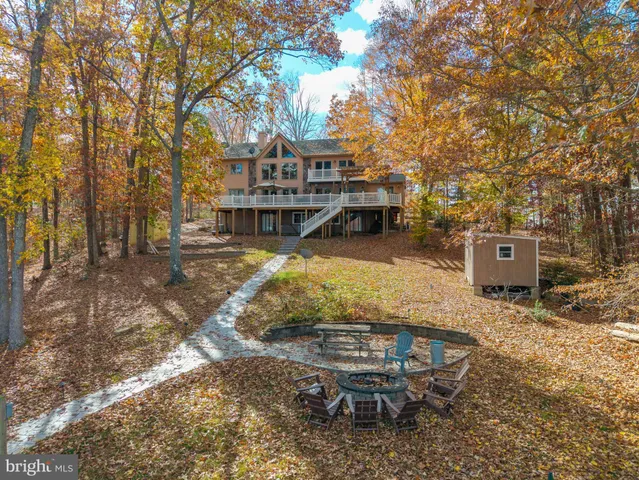 a view of a house with backyard porch and sitting area