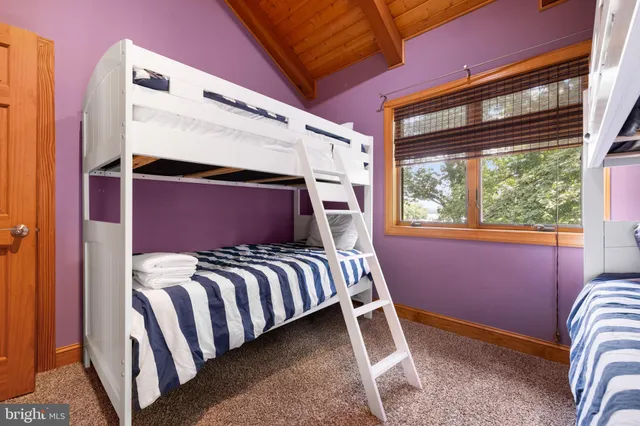 a bedroom with bed and a window