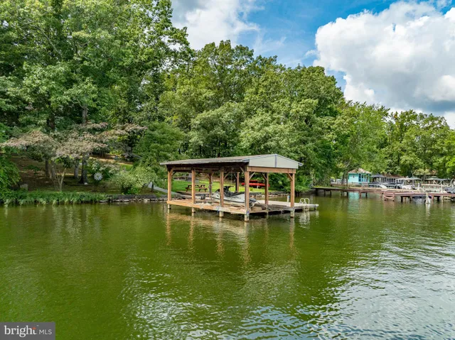 an aerial view of a houses with a lake view
