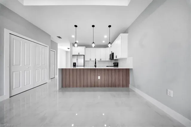 a large kitchen with cabinets and a sink