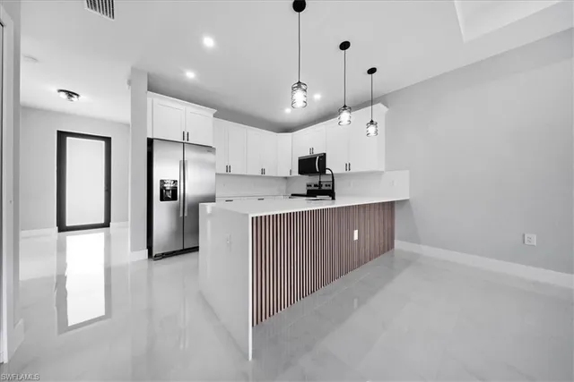 a bathroom with a double vanity sink mirror and shower