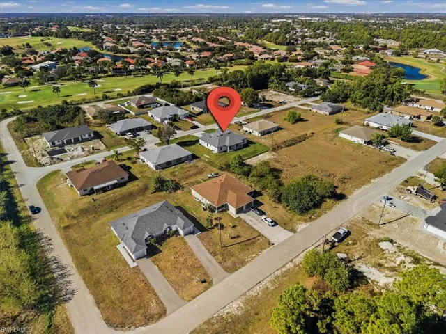 an aerial view of a house with a yard