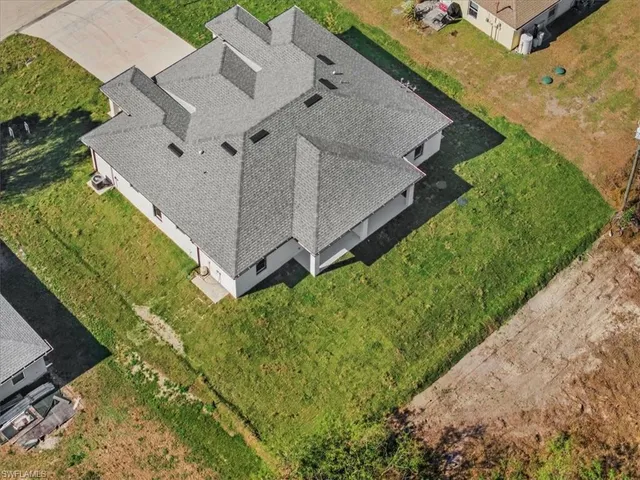 aerial view of a house with a yard