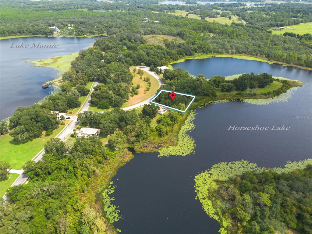 3613 Azurite Court DeLand, FL 32724 - Photo 13 of 20 an aerial view of a house with a yard and lake view