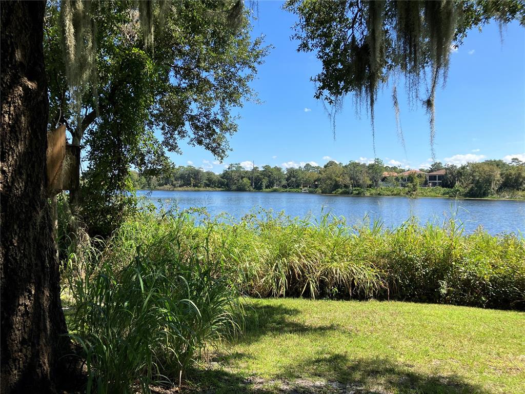 3613 Azurite Court DeLand, FL 32724 - Photo 2 of 20 a view of a lake with a house in the background