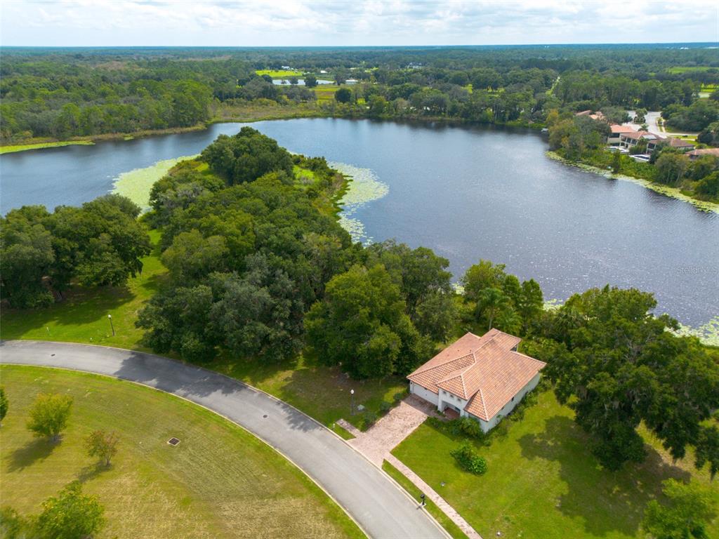 3613 Azurite Court DeLand, FL 32724 - Photo 9 of 20 an aerial view of lake residential house with outdoor space and trees around