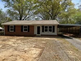 a house with trees in the background