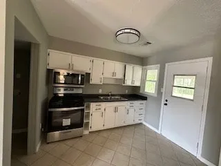 a kitchen with stainless steel appliances a stove sink and cabinets