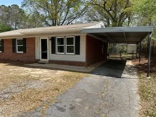 a view of house with backyard outdoor seating area