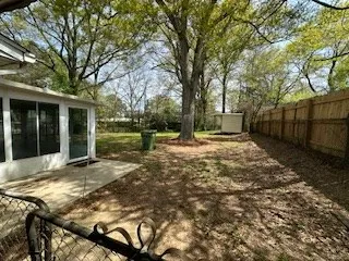 a view of a backyard with large trees