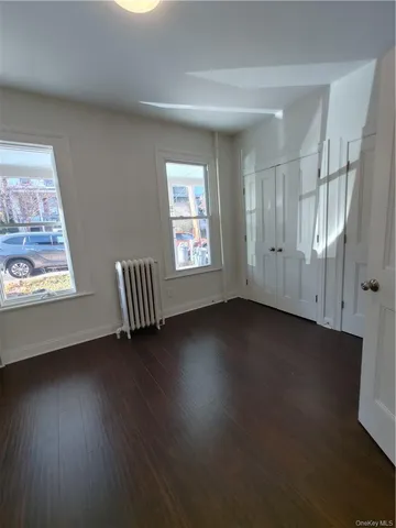 a view of room with hardwood floor and window