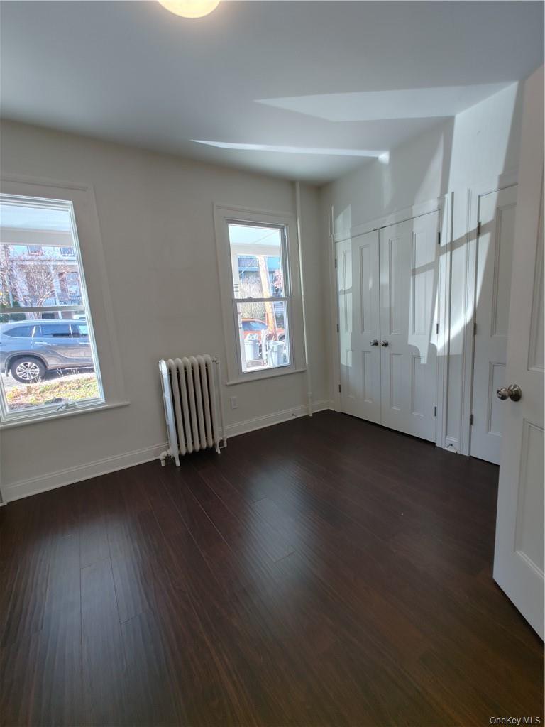 7 Prospect Street, Unit 1 Nyack, NY 10960 - Photo 12 of 18 an empty room with wooden floor and windows