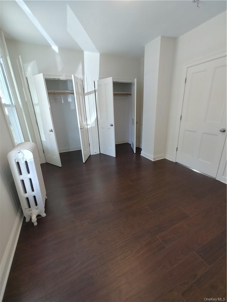 7 Prospect Street, Unit 1 Nyack, NY 10960 - Photo 14 of 18 a view of an empty room with wooden floor and stairs