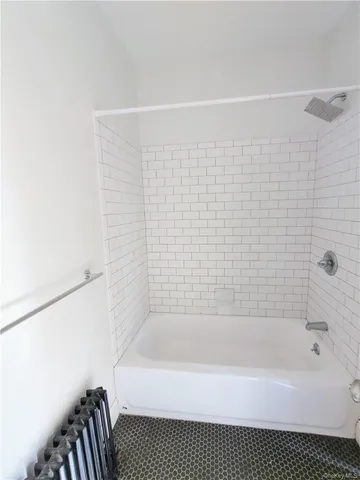 a view of a room with wooden floor and a window