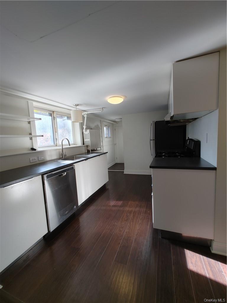 7 Prospect Street, Unit 1 Nyack, NY 10960 - Photo 9 of 18 a kitchen with stainless steel appliances granite countertop a sink and a stove top oven