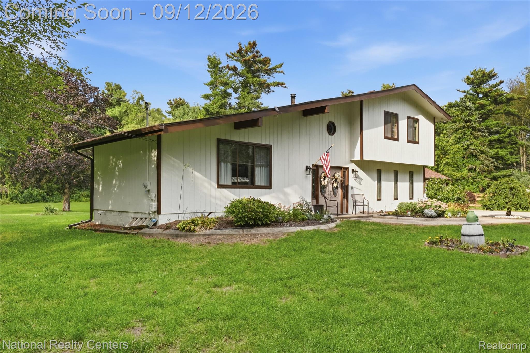 2631 Garden Road Milford, MI 48381 - Photo 33 of 40 Exterior siding with contrasting trim, multiple window styles, and a landscaped front entrance