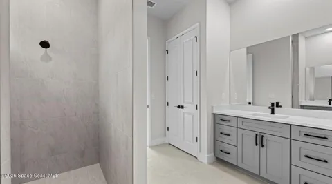 a bathroom with a double vanity sink and mirror