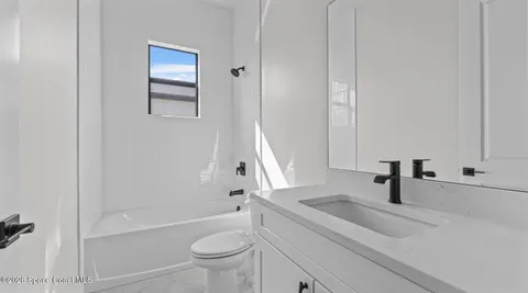 a bathroom with a sink a toilet and a tub