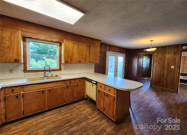 a kitchen with sink cabinets and wooden floor